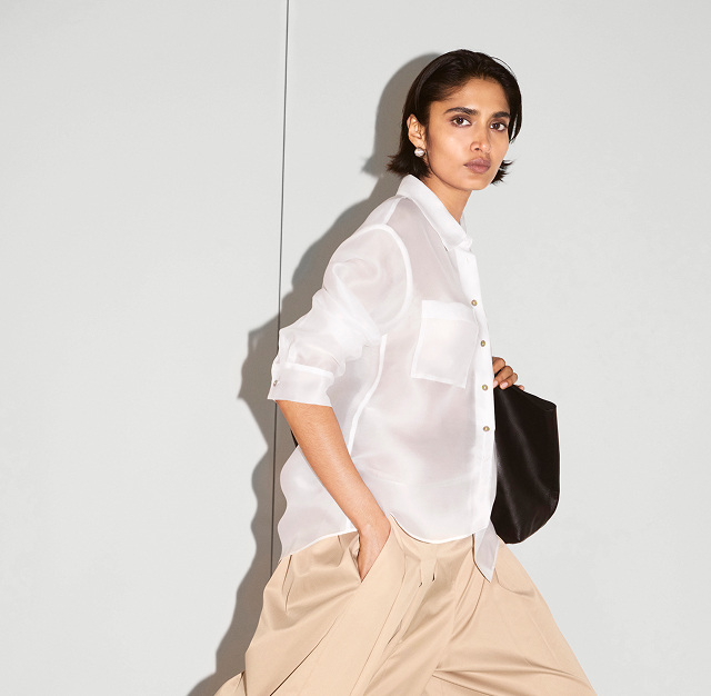 Woman in white shirt and beige pants